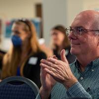 Mentor watching oral presentation.